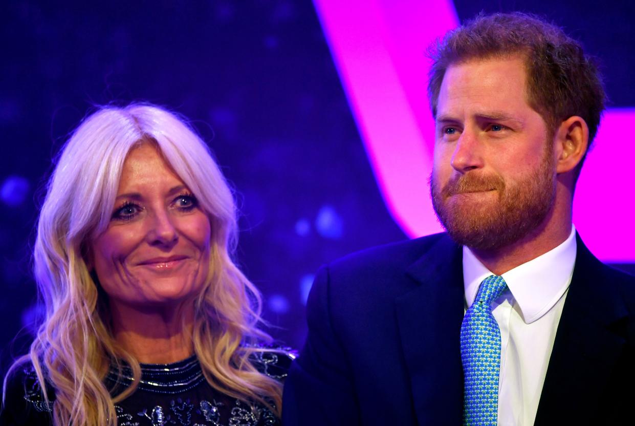 A photo of Britain's Prince Harry, Duke of Sussex tears up on stage alongside television presenter Gaby Roslin as he delivers a speech during the annual WellChild Awards in London on October 15, 2019.