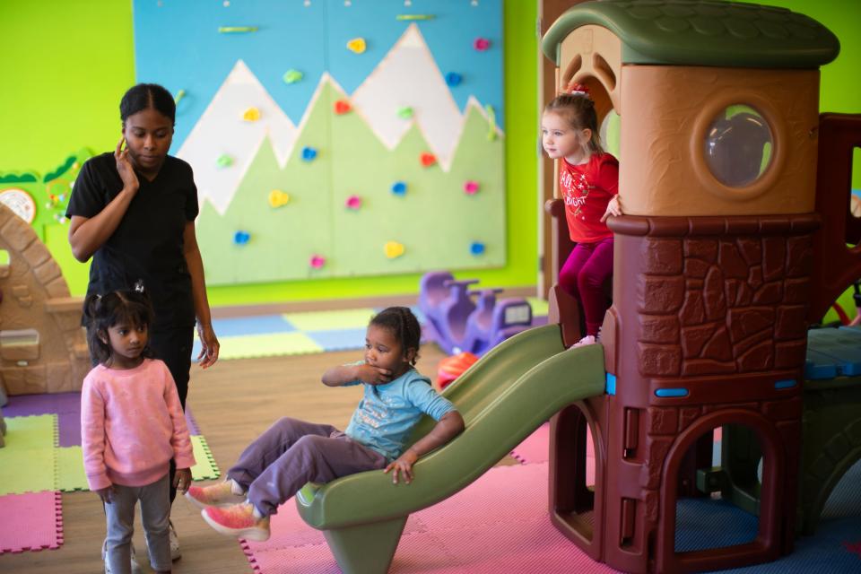 Two and three year olds play, watched over by Aliya Ponder, at Little Incredibles in Columbus.