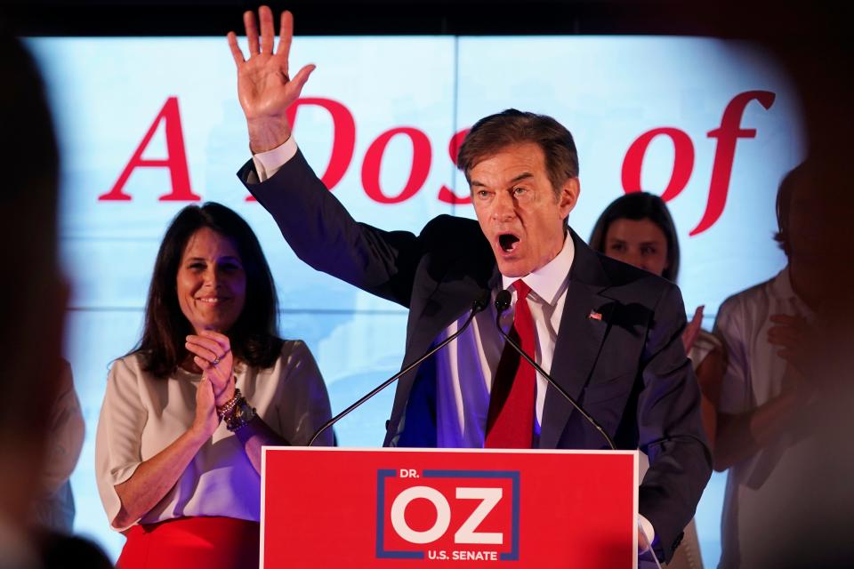 Mehmet Oz, a Republican candidate for U.S. Senate in Pennsylvania, right, waves in front of his wife, Lisa, while speaking at a primary night election gathering in Newtown, Pa., Tuesday, May 17, 2022. (AP Photo/Seth Wenig) ORG XMIT: PASW105