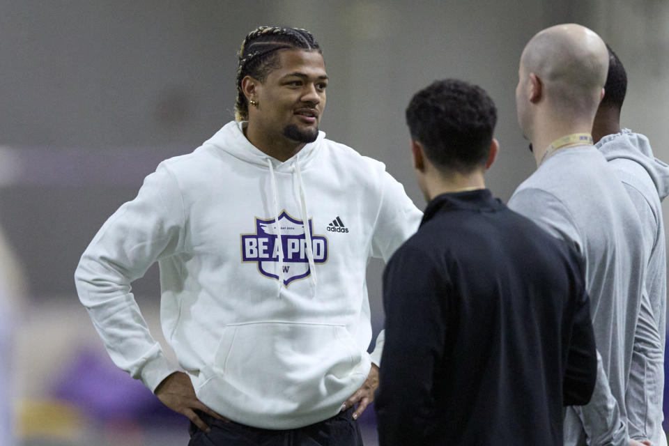 FILE - Washington wide receiver Rome Odunze talks while standing on the field during Washington's NFL Pro Day, Thursday, March 28, 2024, in Seattle. Odunze is a possible first round pick in the NFL Draft.(AP Photo/John Froschauer, File)
