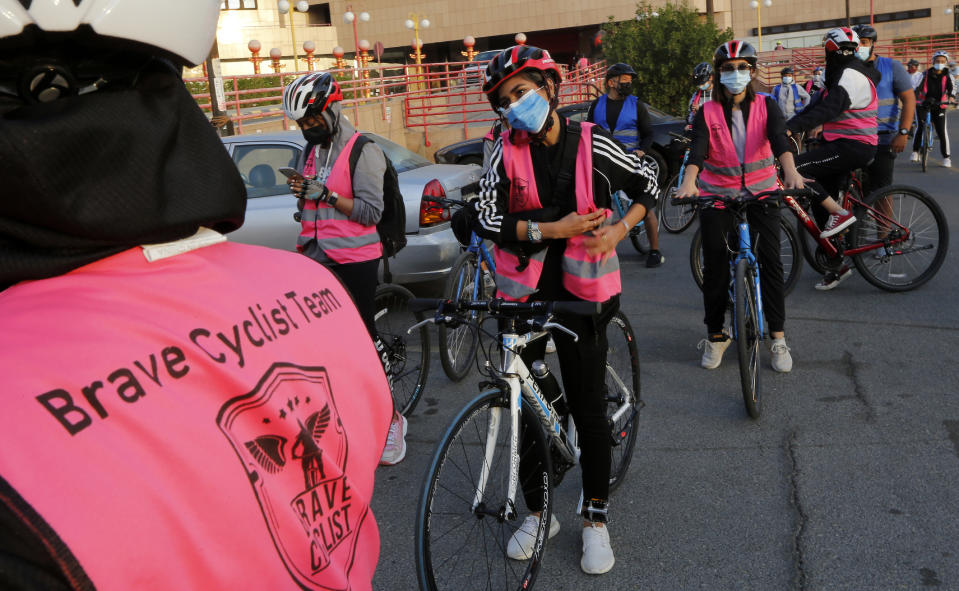 In this March 6, 2021 photo, members of the women's Brave Cyclist team prepare to start a tour in Jiddah, Saudi Arabia. The Brave Cyclist team, which was formed in 2019 aiming to normalize the sport for women, organized a tour cycling ahead of International Women's Day. (AP Photo/Amr Nabil)