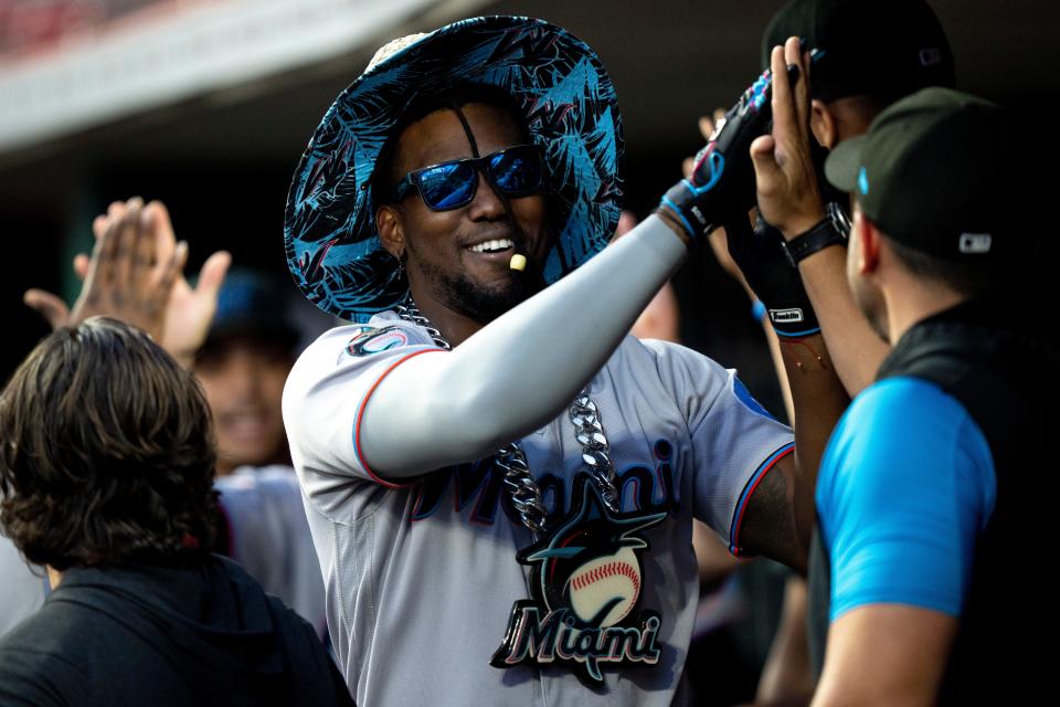 Miami Marlins designated hitter Jorge Soler (12) celebrates with teammates after hitting a two run home run in the seventh inning of the MLB baseball game between Cincinnati Reds and Miami Marlins at Great American Ball Park in Cincinnati on Tuesday, Aug. 8, 2023. 