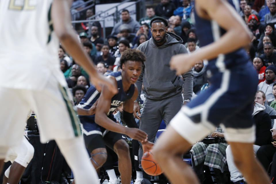 LeBron James keeps a close eye on Bronny on Saturday night. (Joe Robbins/Getty Images)