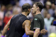 Rafael Nadal, left, of Spain, hugs John Millman, of Australia, after winning their match during the first round of the U.S. Open tennis tournament Tuesday, Aug. 27, 2019, in New York. (AP Photo/Adam Hunger)