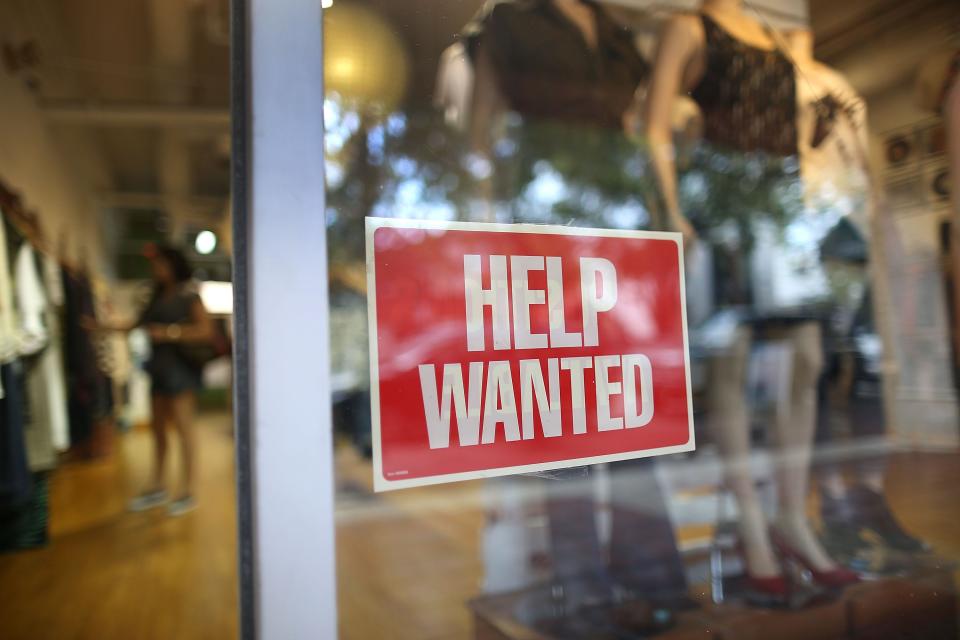 MIAMI -- A help wanted sign is seen in the window of the Unika store.