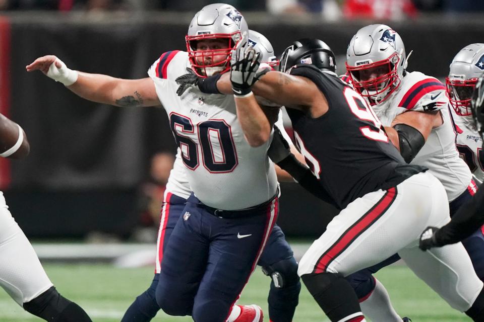 New England Patriots center David Andrews (60) works against the Atlanta Falcons during the first half of an NFL football game, Thursday, Nov. 18, 2021, in Atlanta. (AP Photo/Brynn Anderson)