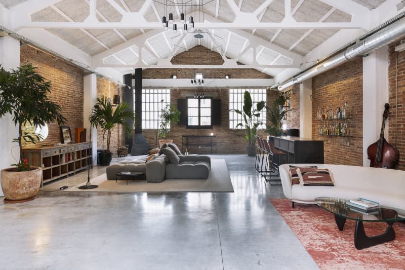 large, airy loft with brick walls and exposed white beams