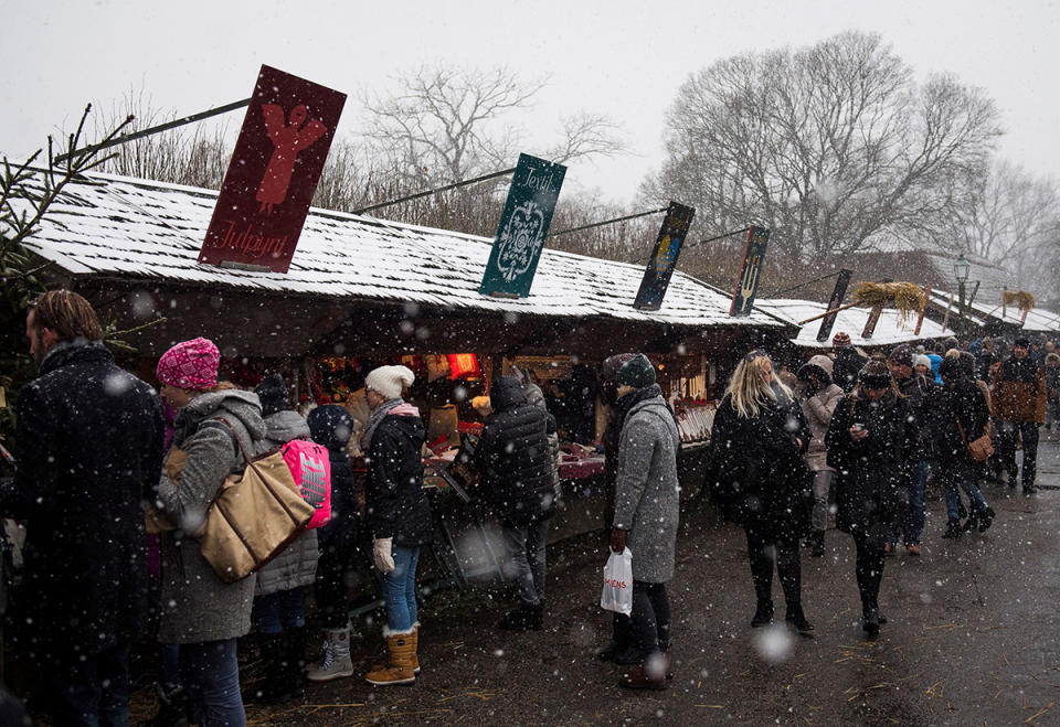 best christmas markets around the world, People visit a Christmas market at the Skansen open air museum during Advent Sunday on November 27, 2016 in Stockholm.   / AFP PHOTO / JONATHAN NACKSTRAND        (Photo credit should read JONATHAN NACKSTRAND/AFP via Getty Images)