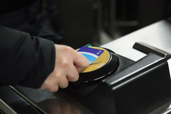 LONDON, ENGLAND - FEBRUARY 14:  A commuter swipes his Oyster card at a London Underground station on February 14, 2012 in London, England.   London's underground rail system, commonly called the tube, is the oldest of its kind in the world dating back to 1890. It carries approximately a quarter of a million people around its network every day along its 249 miles of track and 270 stations. The network has undergone several years of upgrade work and refurbishment in preparation for the Olympic Games which take place this summer. During this time the tube is expected to carry millions of visitors to and from the Olympic Parks. (Photo by Dan Kitwood/Getty Images)