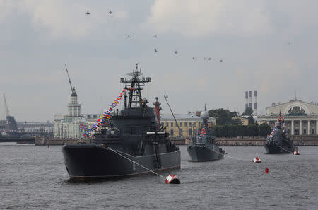 FILE PHOTO: Russian military helicopters fly in formation over navy ships of the Baltic Fleet seen on the Neva River during a rehearsal for the Navy Day parade in St. Petersburg, Russia July 28, 2017. REUTERS/Anton Vaganov/File Photo