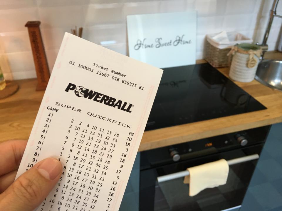 A person holds a Powerball ticket.