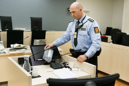 A police officer checks room 250 of the central court in Oslo. Anders Behring Breivik -- the gunman who killed 77 people in Norway's massacres -- showed no emotion as he recalled shooting his victims at point-blank range, but insisted he was a nice person and not a psychiatric case