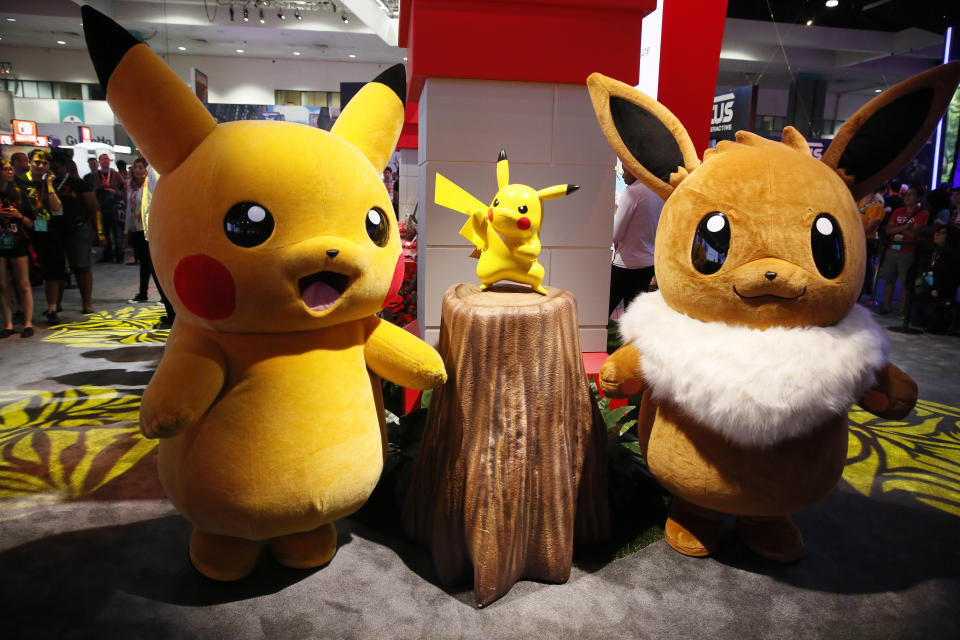 In this Thursday, June 14, 2018, Pikachu and Eevee stand at Nintendo booth during the Electronic Entertainment Expo E3 at the Los Angeles Convention Center. (AP Photo/Damian Dovarganes)