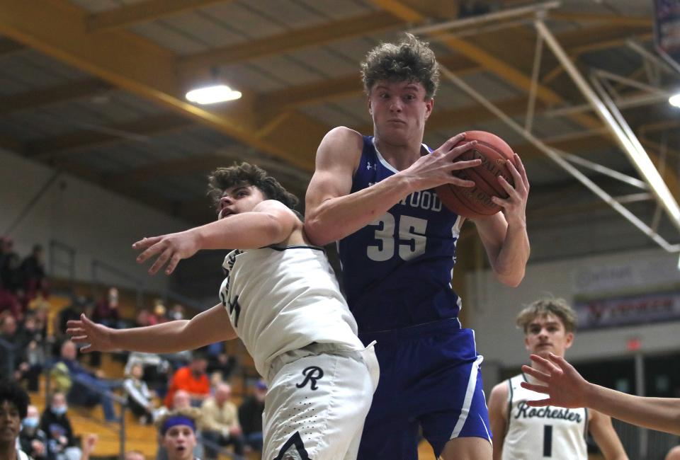 Ellwood's Joseph Roth (35) rebounds the ball during the second half of the Midland Tip-off Tournament game against Rochester on Friday, Dec. 10, 2021, at Methany Field House on Geneva Campus.