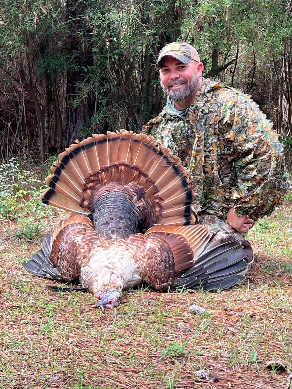 Todd Peltier of Ocean Springs harvested a rare turkey with traits of both black and red color phases.