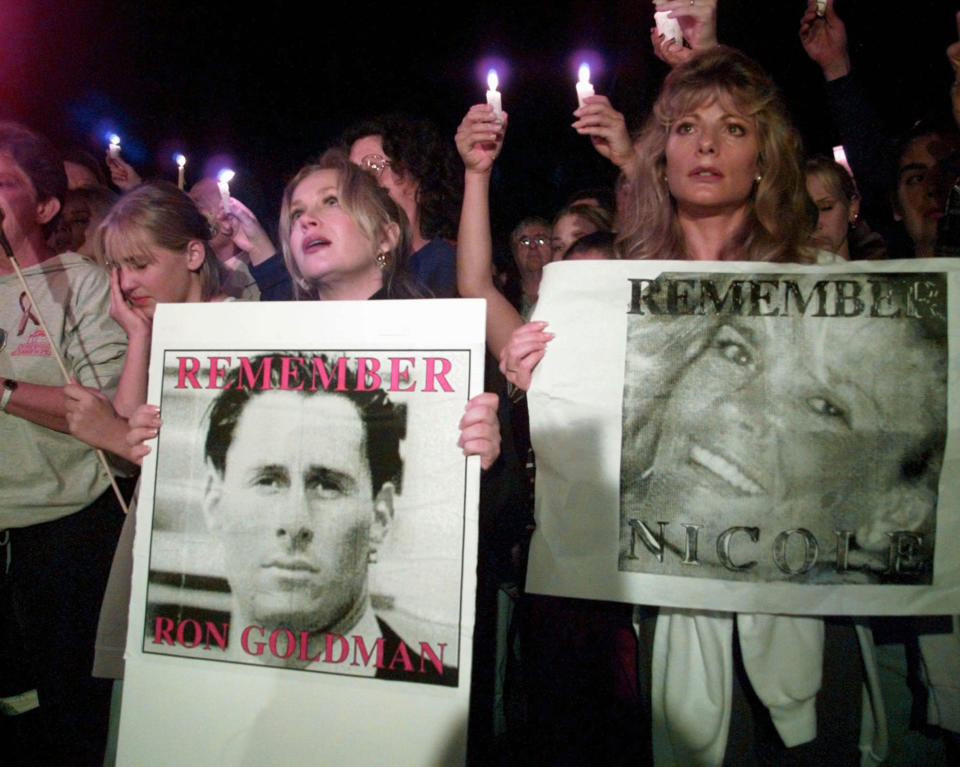 <p>Charlene Tilton, left, and Cindy Josten hold posters of murder victims Nicole Brown Simpson and Ronald Goldman, some of the more than 2,000 participants in a candlelight march to pass by Nicole Brown Simpson’s condominium on Sat., Oct. 7, 1995 in Los Angeles, Calif. (Photo: Eric Draper/AP) </p>