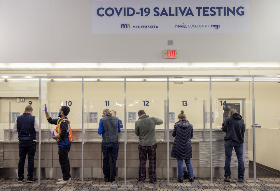 FILE - In this Nov. 12, 2020, file photo, people get tested at the new saliva COVID-19 testing site at the Minneapolis-St. Paul International Airport. With the coronavirus surging out of control, the nation’s top public health agency advised Americans on Thursday, Nov. 19, not to travel for Thanksgiving and not to spend the holiday with people from outside their household. (Elizabeth Flores/Star Tribune via AP, File)