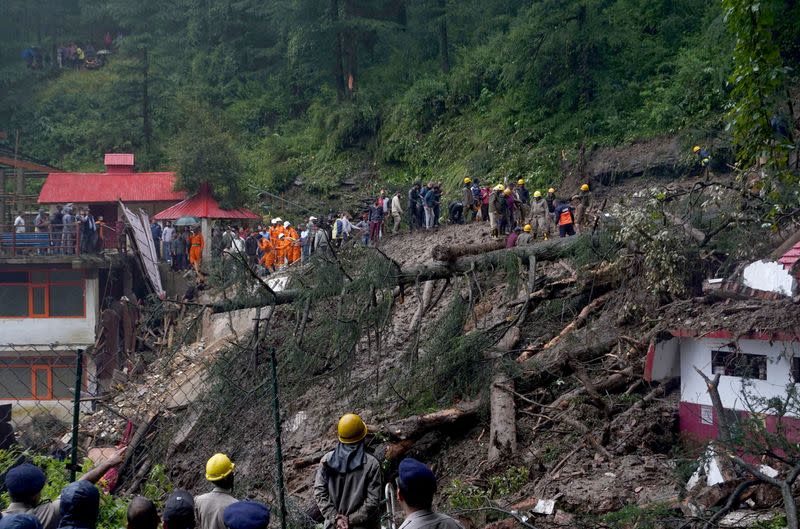 FILE PHOTO: FILE PHOTO: Rescue workers remove the debris as they look for survivors after a landslide following torrential rain in Shimla