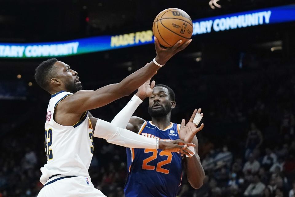 Denver Nuggets forward Jeff Green (32) drives past Phoenix Suns center Deandre Ayton (22) during the first half of an NBA basketball game Sunday, Nov. 21, 2021, in Phoenix. (AP Photo/Ross D. Franklin)