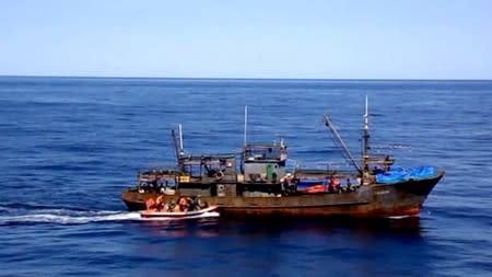 A still image shows a boat with Russian border guards sailing towards a North Korean vessel to detain it and crew members for poaching in waters that Moscow considers its exclusive economic zone