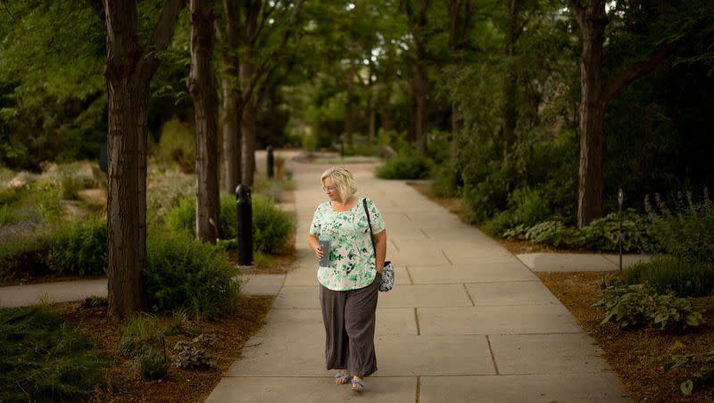 Shelisa Loertscher walks around the Conservation Garden Park in West Jordan on Thursday, July 6, 2023. Loertscher often visits the garden, which she described as her “happy place,” as she continues to deal with long COVID-19 symptoms.