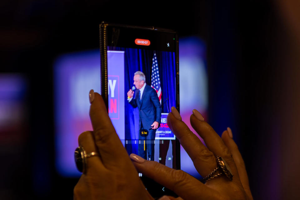 An attendee makes a video of  Robert F. Kennedy Jr. speaking at the rally (Marshall Tidrick for NBC News)