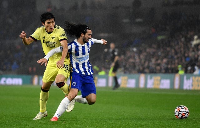 Arsenal’s Takehiro Tomiyasu, left, and Brighton's Marc Cucurella battle for the ball