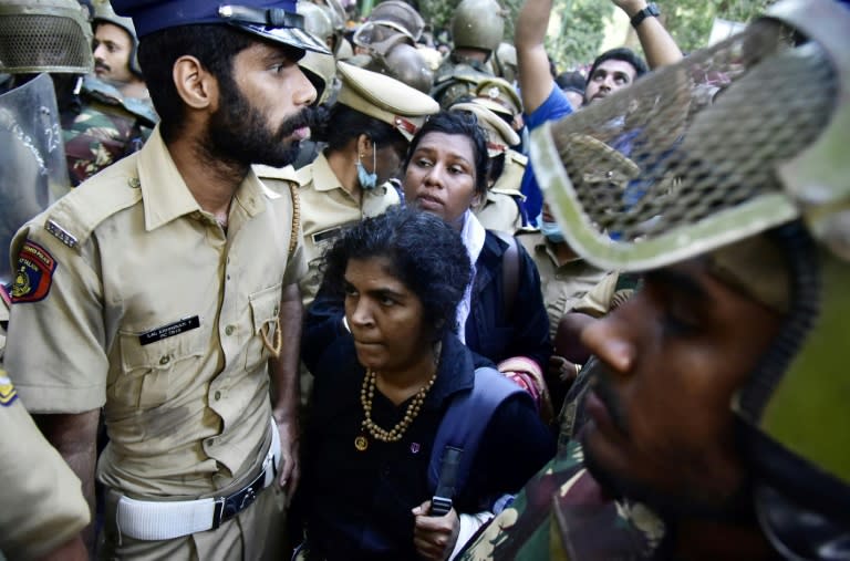 Indian police escort Hindu devotees Kanakadurga and Bindu Ammini during their first attempt to enter the temple