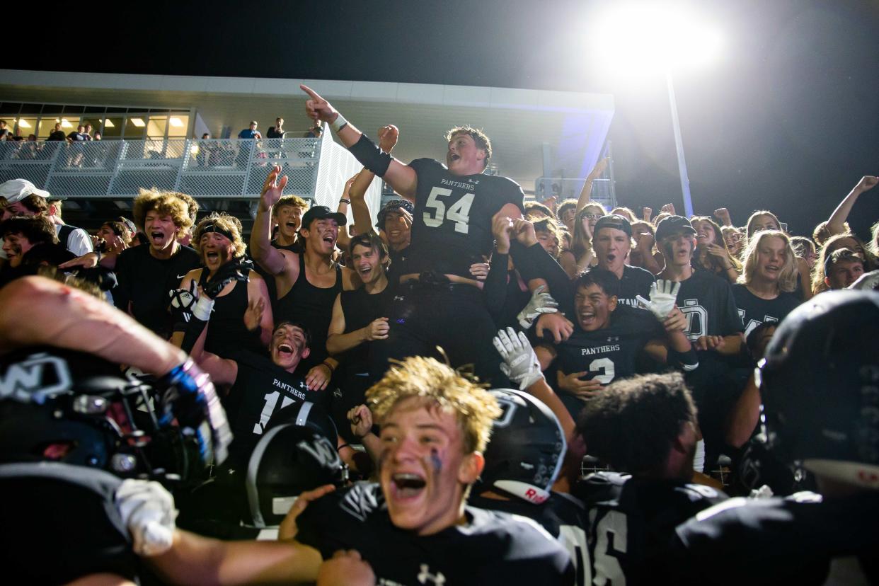 West Ottawa's Cooper Terpstra celebrates with his teammates and the panther student section after their win over Portage Northern in the first ever game in the new Stadium Thursday, Sept. 1, 2022, at West Ottawa Stadium. 