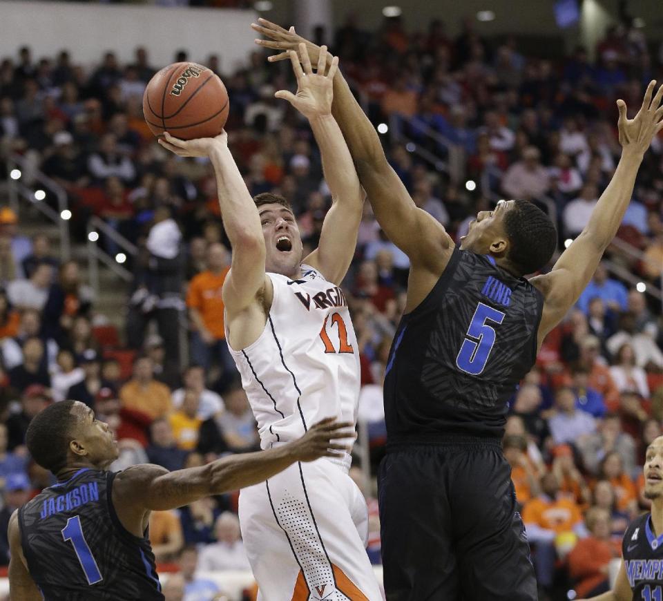 Virginia guard Joe Harris (12) shoots against Memphis' Nick King (5) and Joe Jackson (1) during the first half of an NCAA college basketball third-round tournament game, Sunday, March 23, 2014, in Raleigh. (AP Photo/Gerry Broome)