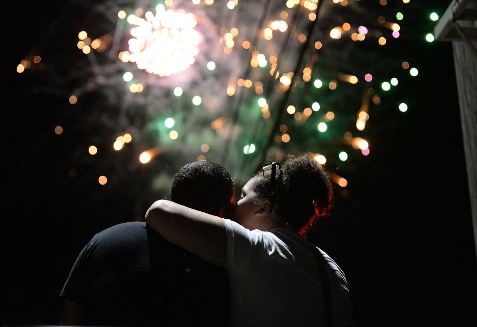 Jordan Fisher and girlfriend Betsy Cappra, kiss each other on top of a pickup truck during the fireworks  at the Summer Celebration at Hopewell Park in Taunton on Friday, August 27, 2021. 