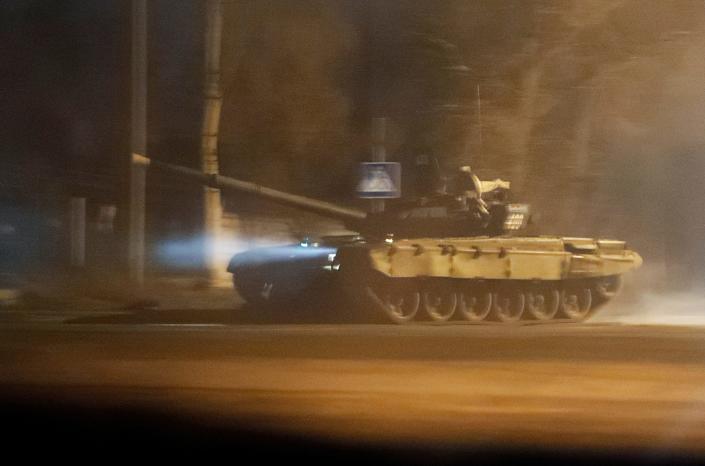 A tank drives along a street after Russian President Vladimir Putin ordered the deployment of Russian troops to two breakaway regions in eastern Ukraine following the recognition of their independence, in the separatist-controlled city of Donetsk, Ukraine February 22, 2022. REUTERS/Alexander Ermochenko