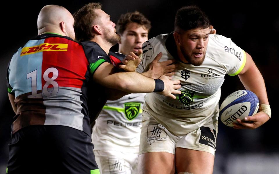 Toulouse's Emmanuel Meafou in action with Harlequins' Dillon Lewis and Will Evans