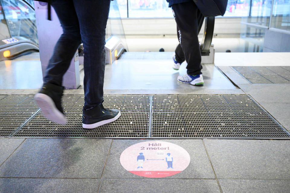 Image: A sticker on a street to ask people to keep social distances amid the new coronavirus pandemic in central Stockholm (Henrik Montgomery / AFP - Getty Images)