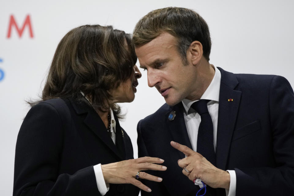 France's President Emmanuel Macron, right, talks with U.S Vice President Kamala Harris, during the Paris Peace Forum, in Paris, Thursday, Nov. 11, 2021. Some world leaders and internet giants are expected to issue a global call to better protect children online during a Paris summit of about 30 heads of state and government, including U.S. Vice-President Kamala Harris. (AP Photo/Christophe Ena)