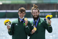 Gold medalists Fintan Mc Carthy and Paul O'Donovan of Ireland celebrate during the medal ceremony for the lightweight men's rowing double sculls final at the 2020 Summer Olympics, Thursday, July 29, 2021, in Tokyo, Japan. (AP Photo/Lee Jin-man)