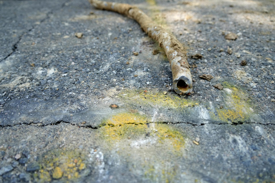 FILE - A lead water service line from 1927 lays on the ground on a residential street after being removed on June 17, 2021, in Denver. The Environmental Protection Agency on Thursday, Dec. 1, 2022, approved a nearly $700 million plan to remove all lead water pipes in the Denver region. (AP Photo/Brittany Peterson, File)