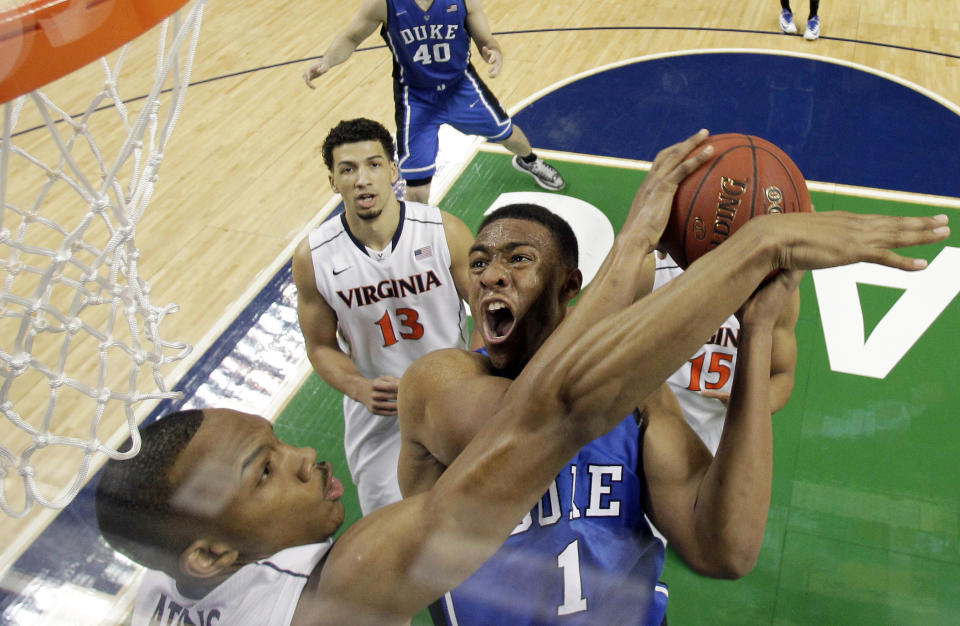 FILE - In this March 16, 2014 file photo, Duke's Jabari Parker (1) tries to shoot over Virginia's Darion Atkins during the first half of an NCAA college basketball game in the championship of the Atlantic Coast Conference tournament in Greensboro, N.C. Parker was selected to The Associated Pressnam All-America team, released Monday, March 31, 2014. (AP Photo/Bob Leverone, File)