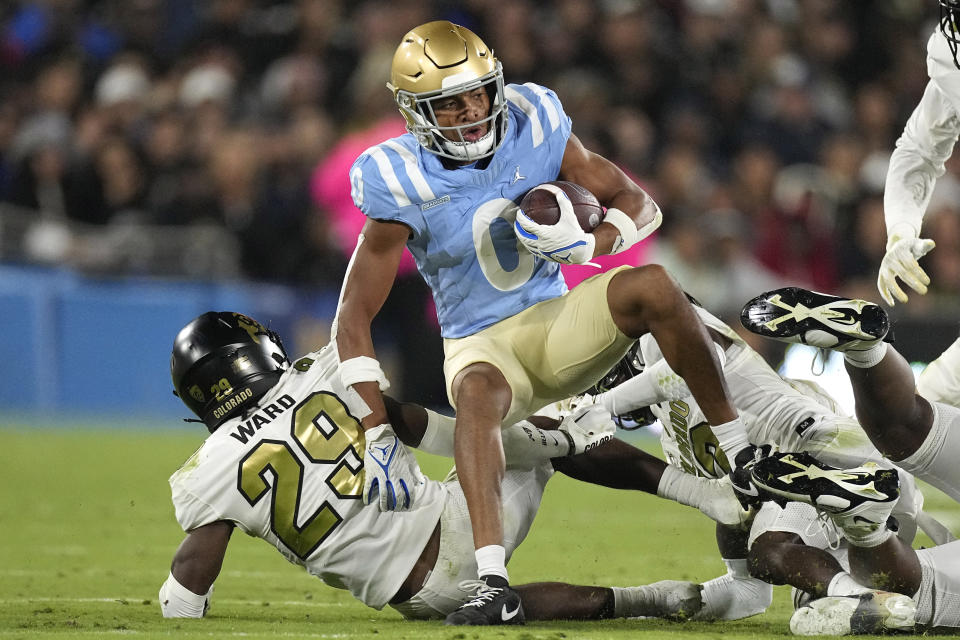 UCLA wide receiver Kam Brown, center, is tackled by Colorado safety Rodrick Ward, left, and cornerback Travis Hunter during the second half of an NCAA college football game Saturday, Oct. 28, 2023, in Pasadena, Calif. (AP Photo/Mark J. Terrill)