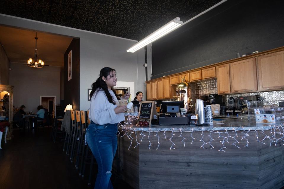 Customers idly chat at a locally owned coffee shop in Liberal, Kansas. The business open last year, but has struggled, and owner Shandon Classen hopes the tools like AI can change that.