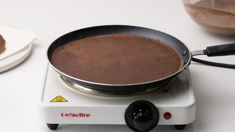 chocolate crepe cooking in pan