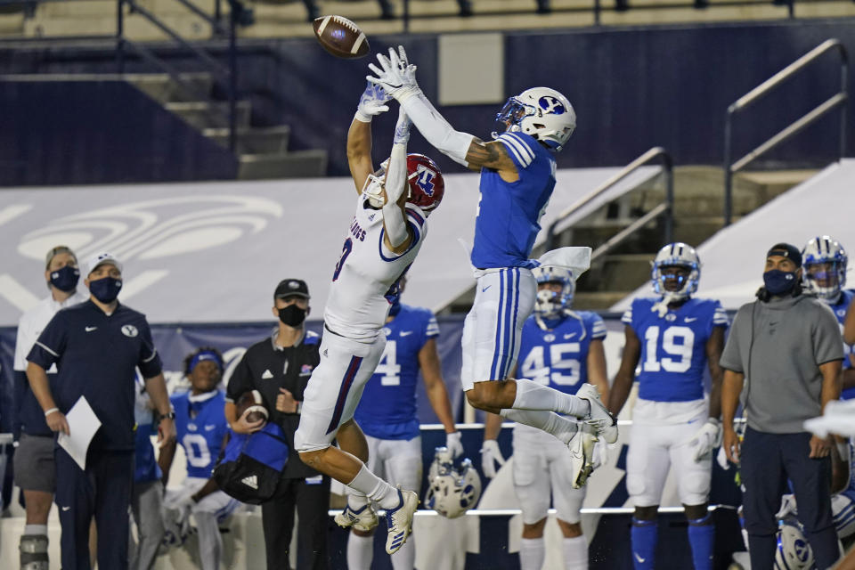 BYU defensive back Troy Warner, right, incepts a pass intended for Louisiana Tech wide receiver Griffin Hebert, left, during the first half of an NCAA college football game Friday, Oct. 2, 2020, in Provo, Utah. (AP Photo/Rick Bowmer, Pool)