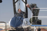 Air Force Secretary Frank Kendall, right, and Maj. Ryan Forystek, an X-62A VISTA Pilot for SecAF flight, climb into the cockpit of the X-62A VISTA aircraft at Edwards Air Force Base, Calif., on Thursday, May 2, 2024. The AI-controlled aircraft that flew Kendall served as a public statement of confidence in the future role of AI in air combat. The military is planning to use the technology to operate an unmanned fleet of 1,000 aircraft. (AP Photo/Damian Dovarganes)