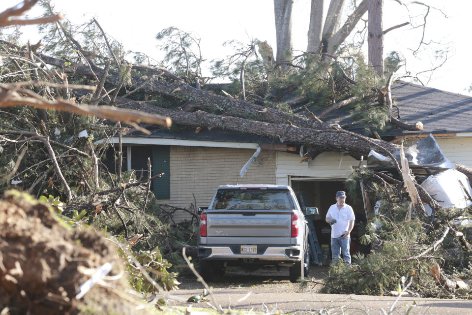 A homeowner venturs out to survey the damage Saturday 25, 2023, in Amory, Miss. Emergency officials in Mississippi say several people have been killed by tornadoes that tore through the state on Friday night, destroying buildings and knocking out power as severe weather produced hail the size of golf balls moved through several southern states. (Thomas Wells/The Northeast Mississippi Daily Journal via AP)