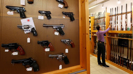 Handguns and sporting guns are displayed at Wyss Waffen gun shop in the town of Burgdorf, Switzerland August 10, 2016. REUTERS/Arnd Wiegmann