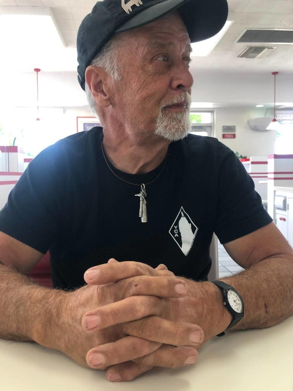 Mike Corbett donning a Yosemite Climbing Association shirt. He worked as chief docent of the association’s climbing museum in Mariposa.