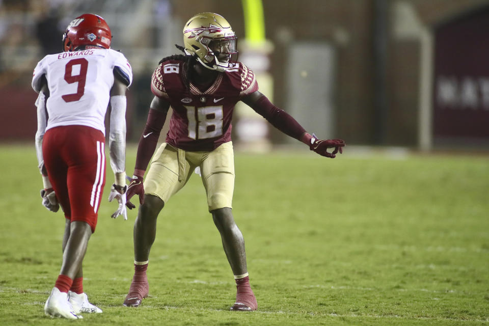 At right, Florida State defensive back Travis Jay (18) checks off as he gets ready to defend Jacksonville State wide receiver Ahmad Edwards (9) in the third quarter of an NCAA college football game Saturday, Sept. 11, 2021, in Tallahassee, Fla. Jacksonville State won 20-17. (AP Photo/Phil Sears)