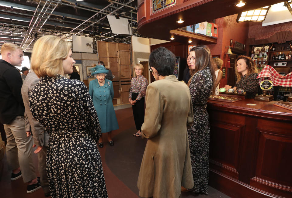 MANCHESTER, ENGLAND - JULY 08: Queen Elizabeth II meets actors and members of the production team during a visit to the set of the long running television series Coronation Street, on July 8, 2021 in Manchester, England. (Photo by Scott Heppell - WPA Pool/Getty Images))