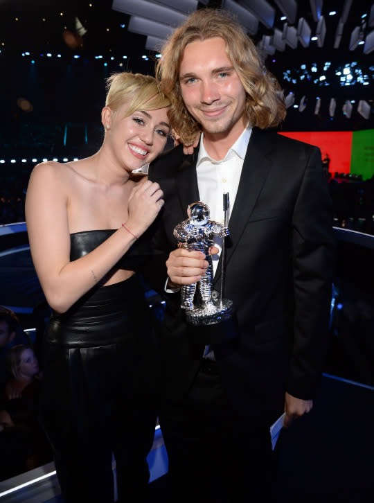 <p>A year after Twerkgate, Miley returned to the VMAs to accept a Video of the Year award for “Wrecking Ball” and tried to class things up, using her time in the spotlight to draw awareness to an important issue: teen homelessness. Miley didn’t even give a speech, instead sitting on the edge of the stage in tears (real tears, not “Wrecking Ball”-video tears) while her date, a young homeless man named Jesse Helt, accepted the award on her behalf. Unfortunately, Miley was still unable to entirely avoid controversy, when it was revealed that Helt had a criminal past; his TV appearance prompted police to send out a warrant for his arrest for probation violation, and he was later sentenced to six months in jail. (Source: Getty Images) </p>