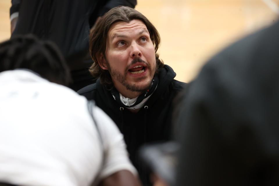 Houston Head Coach Mike Miller talks to his team during a timeout in their home game against Arlington on Friday, Jan. 29, 2021. 